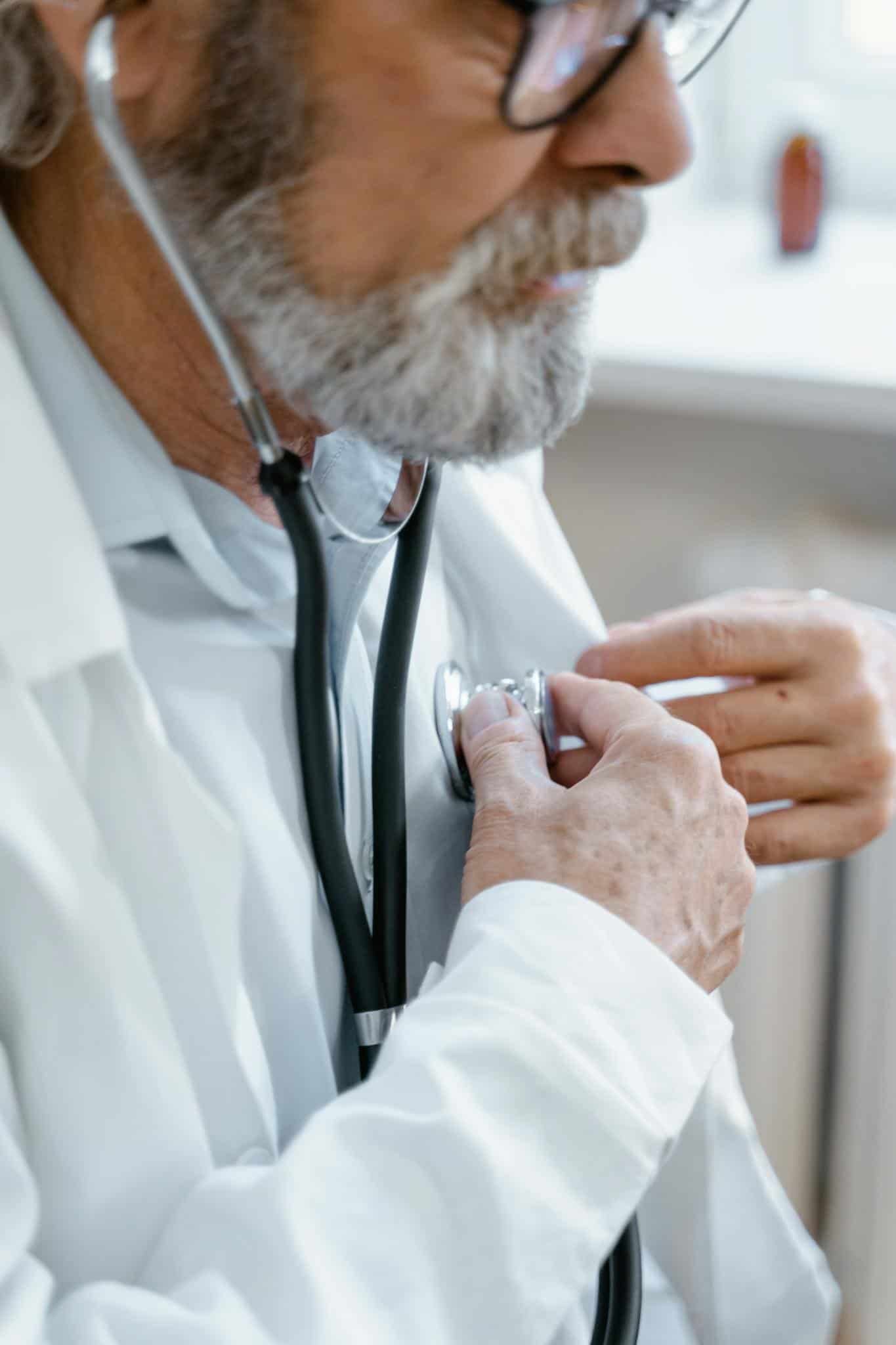 a close-up of a doctor's hand holding a stethoscope