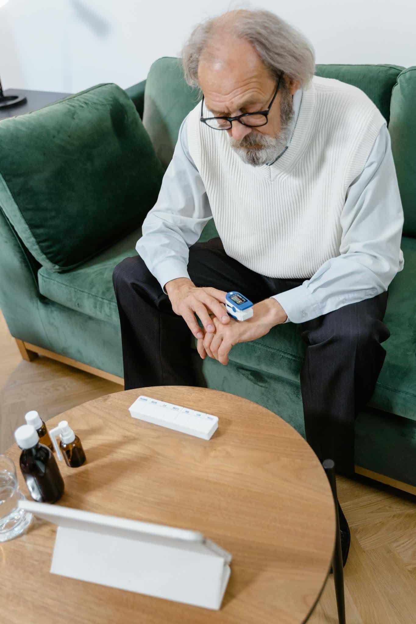 a man sitting on a couch looking at a device