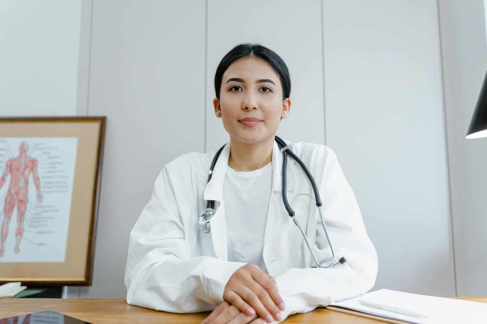 a woman in a white coat with a stethoscope around her neck